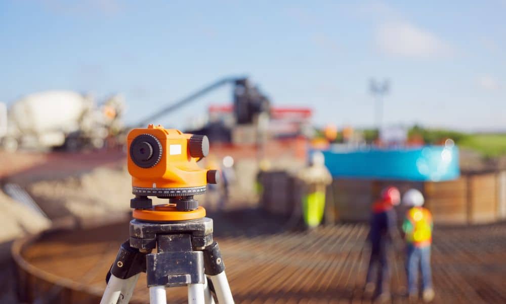 Surveying equipment used to collect data for elevation certificates at a construction site in Houston