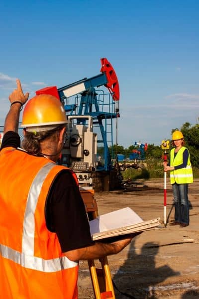 Licensed surveyors using GPS equipment to mark property survey boundaries on site