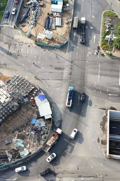Drone aerial view of city intersection and construction site representing ALTA Title Survey mapping after street closure
