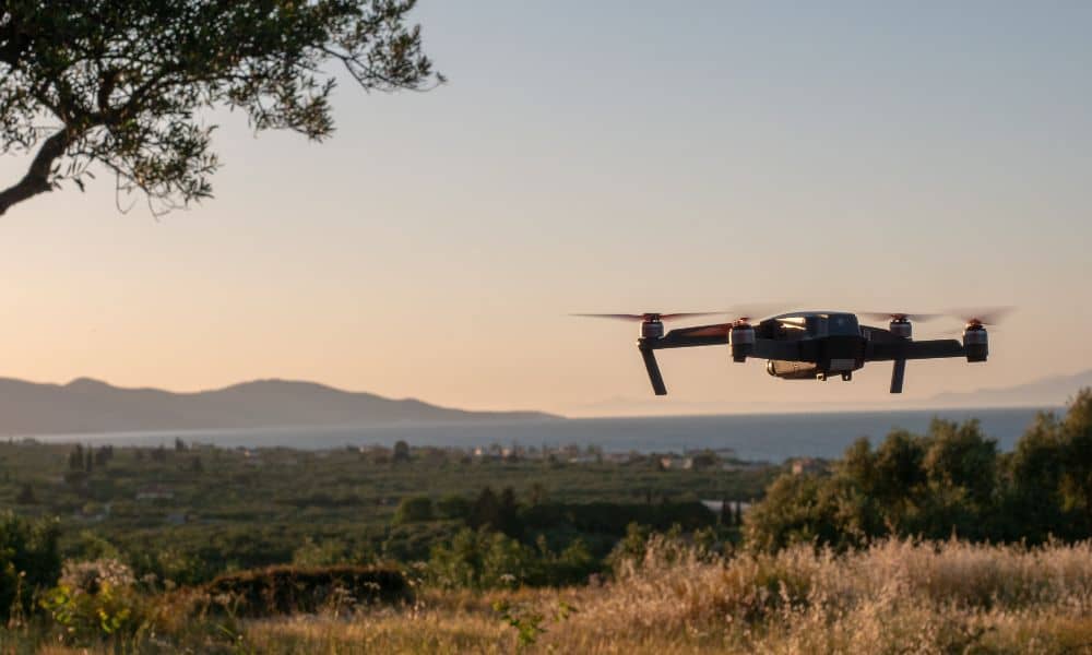 A drone surveying a coastal landscape, capturing updated images used for planning and environmental protection