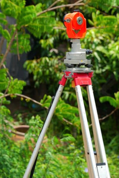 Survey equipment set on a tripod used to check land changes after storms and help update flood elevation certificates
