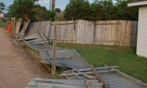 Storm-damaged fence causing homeowners to search for a licensed land surveyor near me