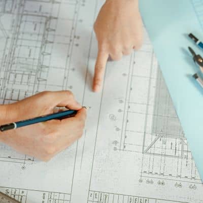 Construction surveyor reviewing site elevation drawings and grading plans
